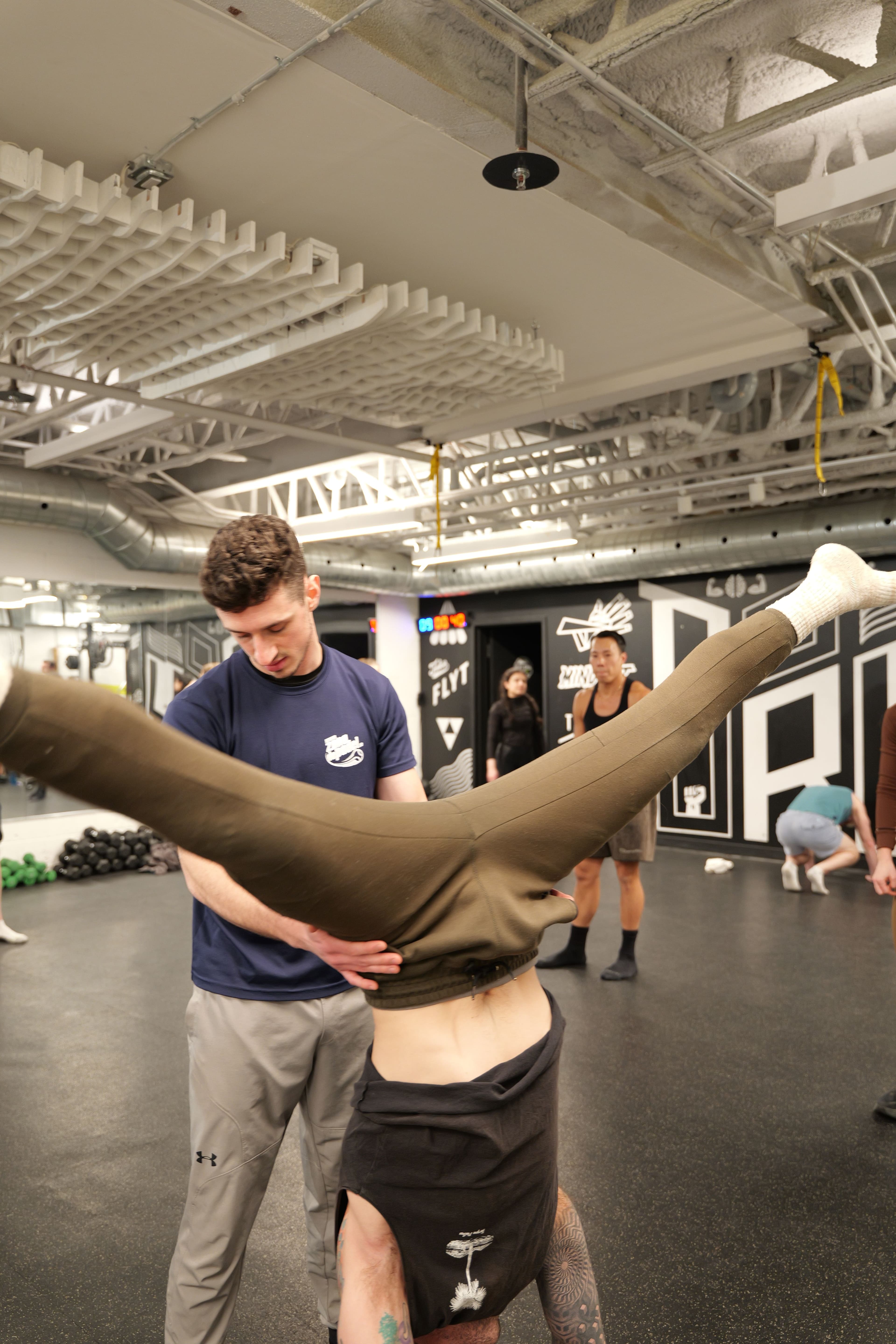 Jonny spotting a student in a handstand